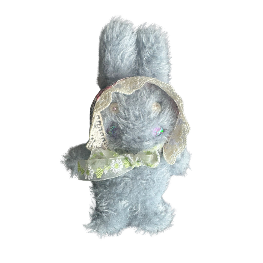 Light blue handmade plush bunny with floral lace bonnet and green daisy ribbon – soft collectible toy by Mimi Planet, vintage aesthetic