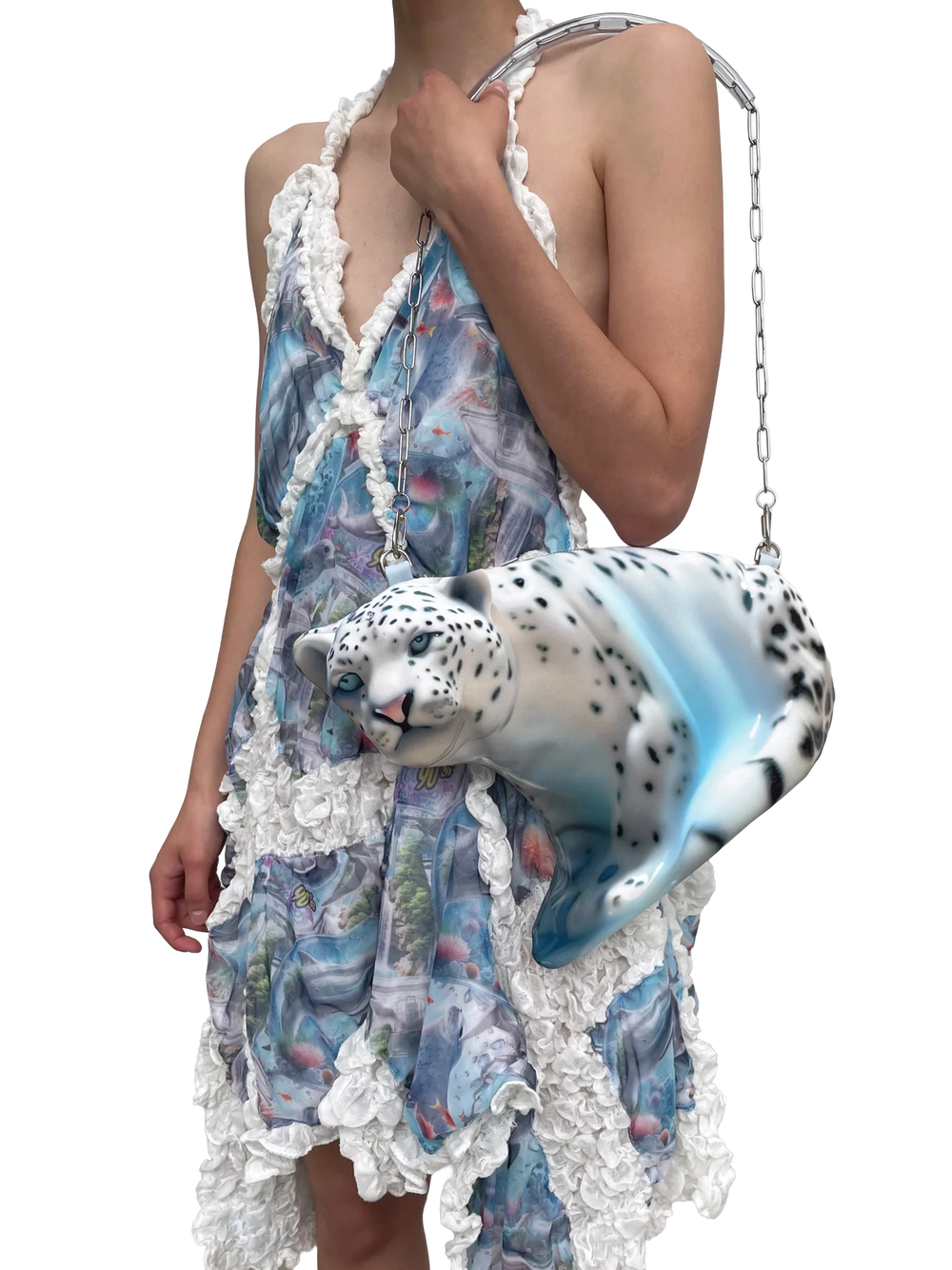 Person wearing a floral dress holding a leopard-shaped handbag on a white background