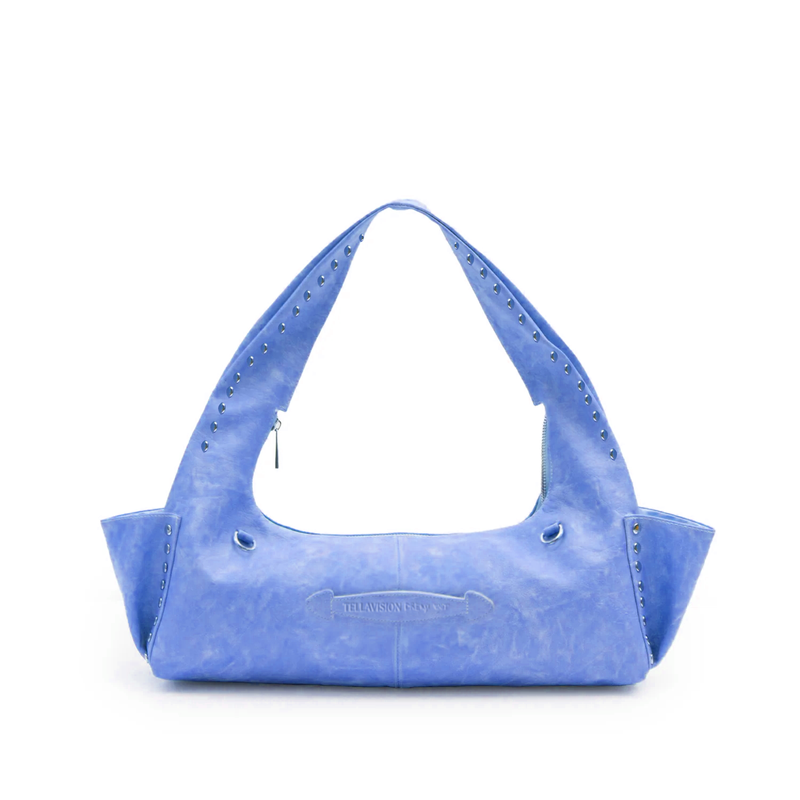 Blue handbag with studded details on a white background