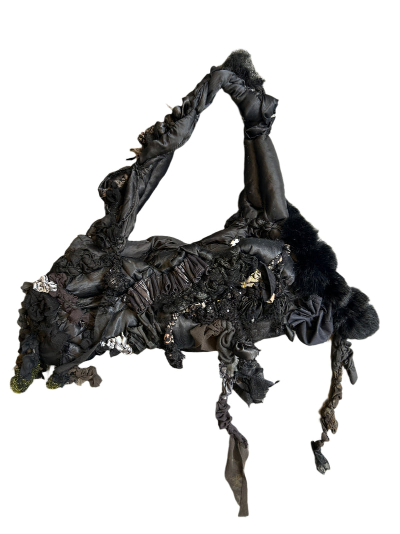 Black lace handbag on a wooden surface