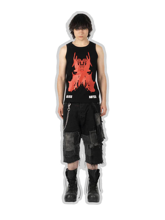 Person wearing a black sleeveless shirt with red graphic design and black shorts on a white background