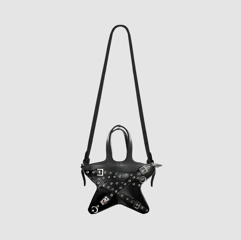 Edgy black star-shaped handbag with bondage-inspired straps and silver-tone hardware, featuring adjustable shoulder straps and a unique, standout design.