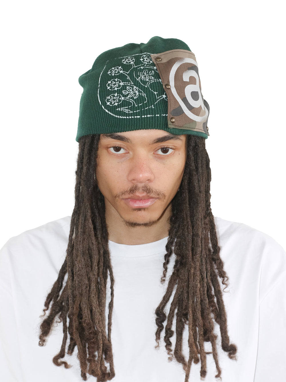 Person wearing a green beanie with a logo on a white background
