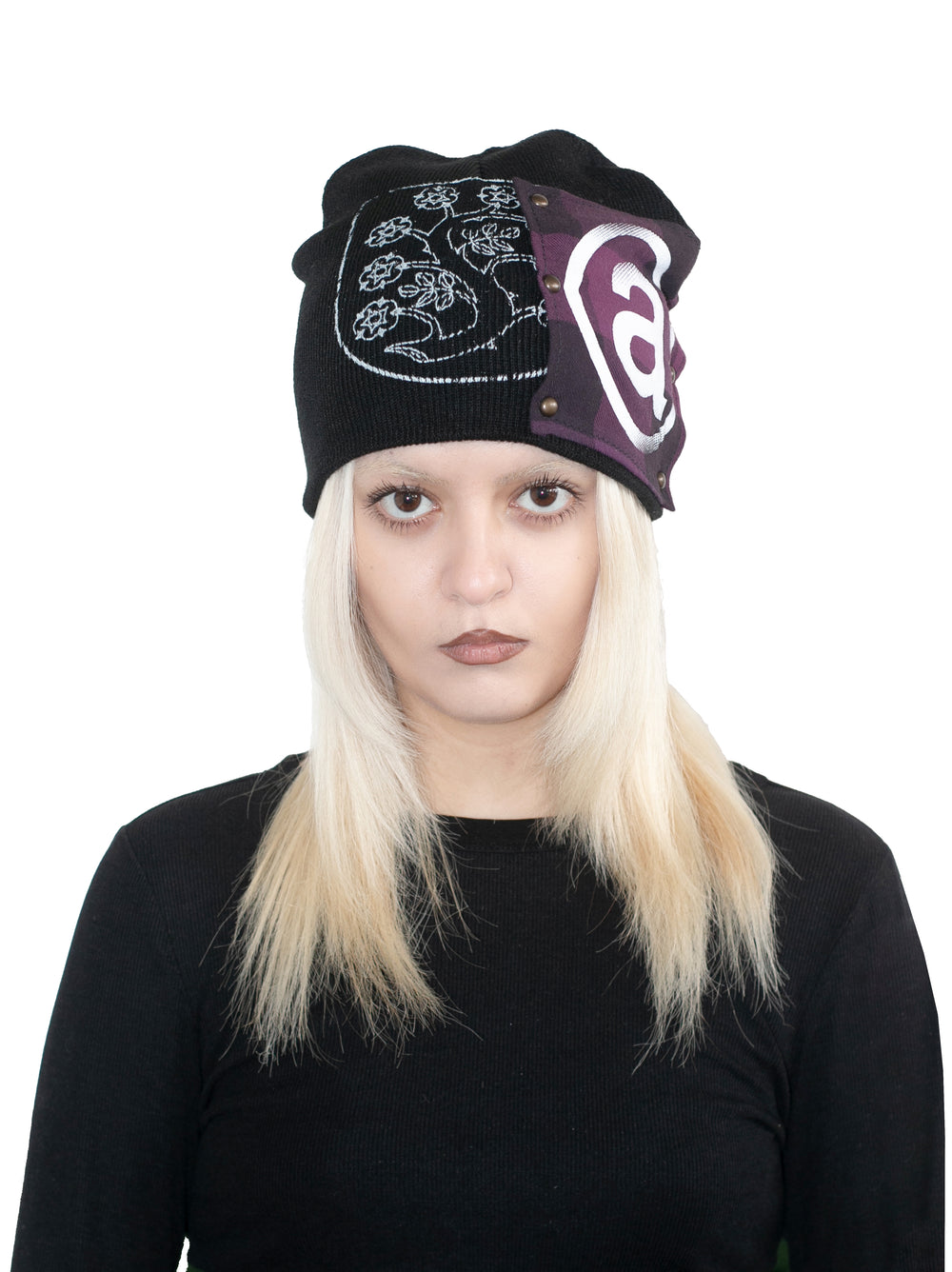 Person wearing a black beanie with a logo on a white background