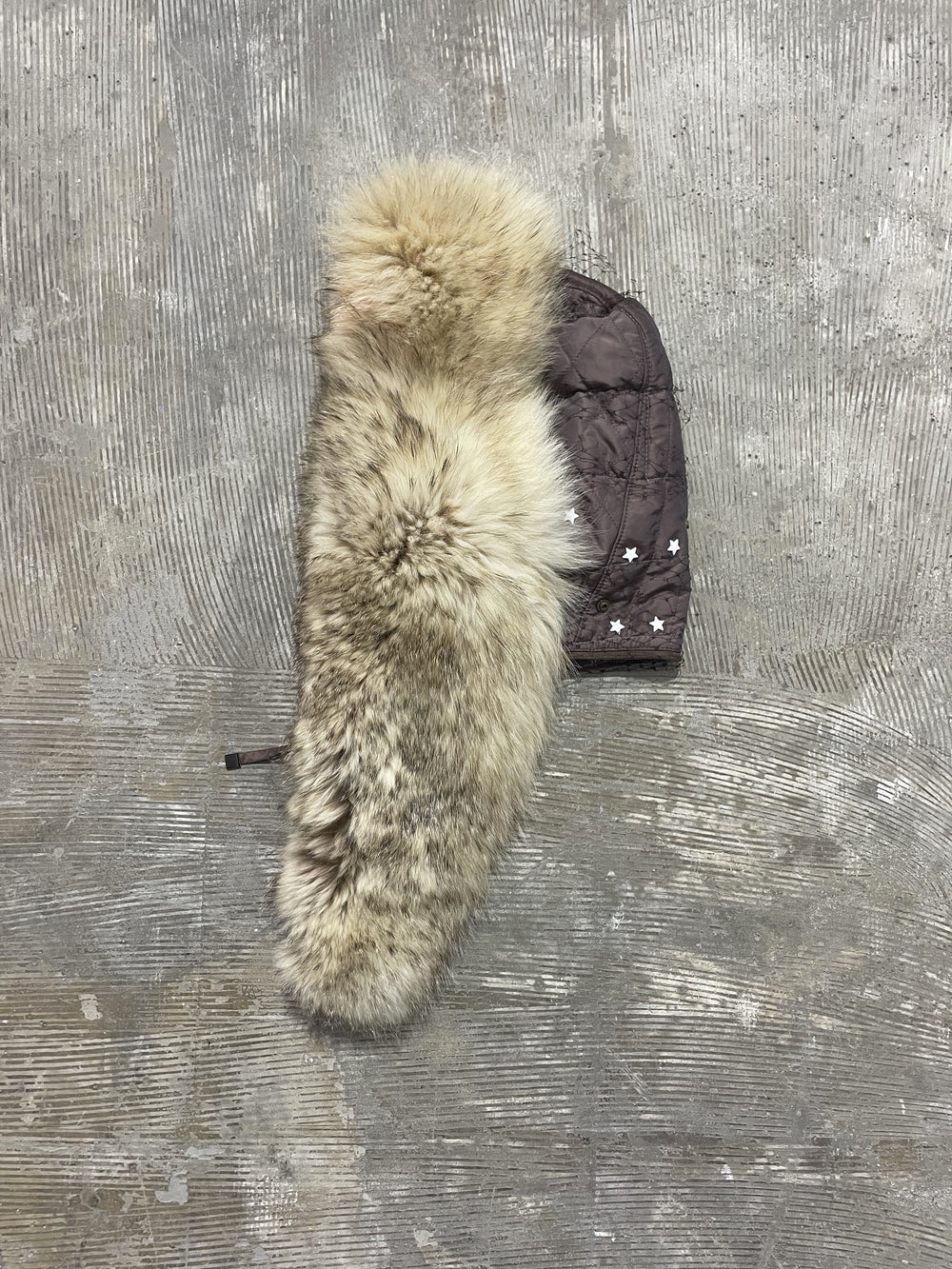 Detachable fur hood scarf flat lay, showcasing fur texture and hood construction.