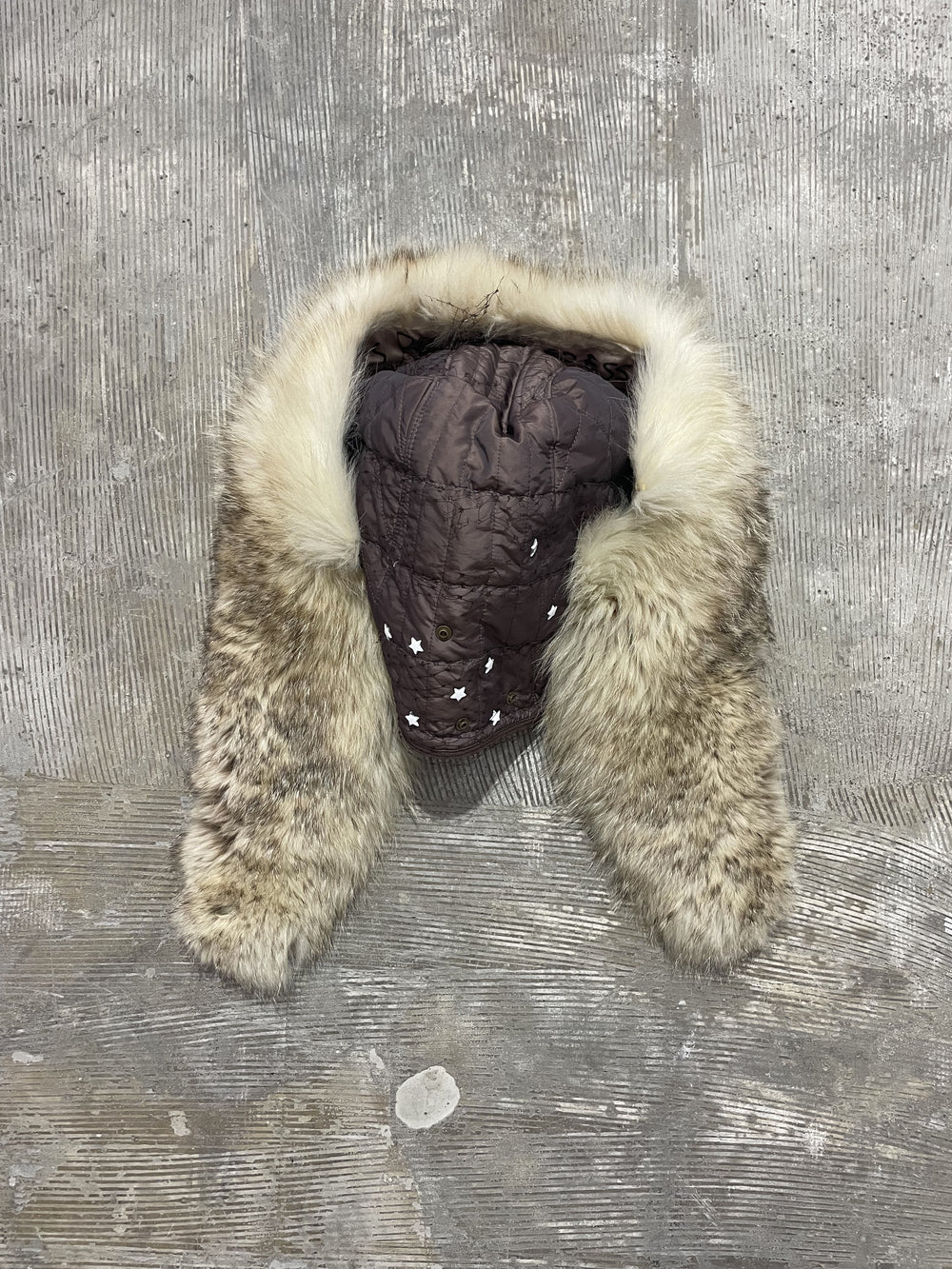 Detachable fur hood scarf laid flat, showing quilted hood and long fur panels.