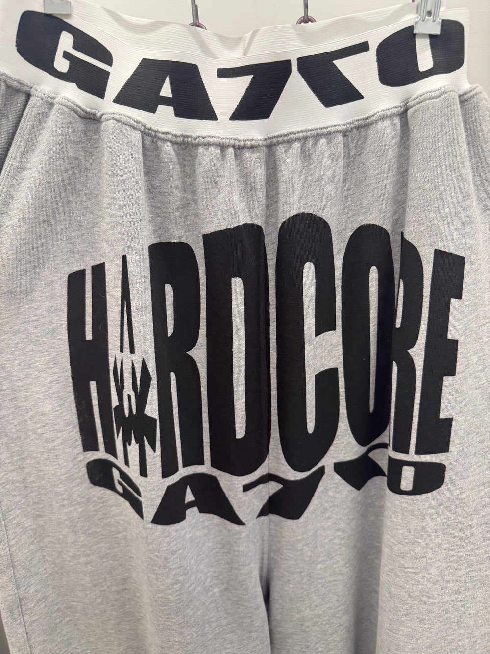 Gray sweatpants with black text and 'GA7CO' branding on a white background