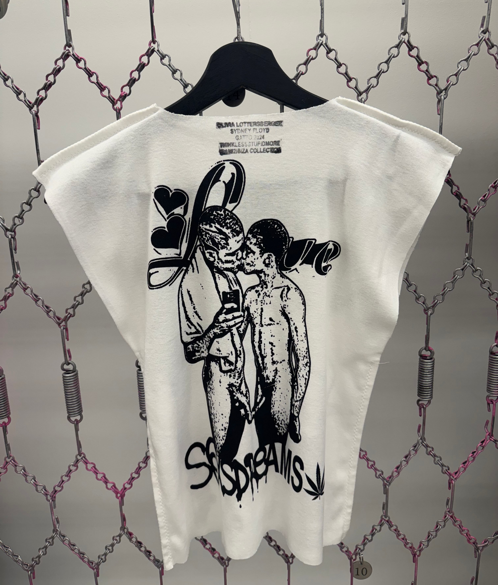 White t-shirt with black graphic design on a hanger against a patterned background