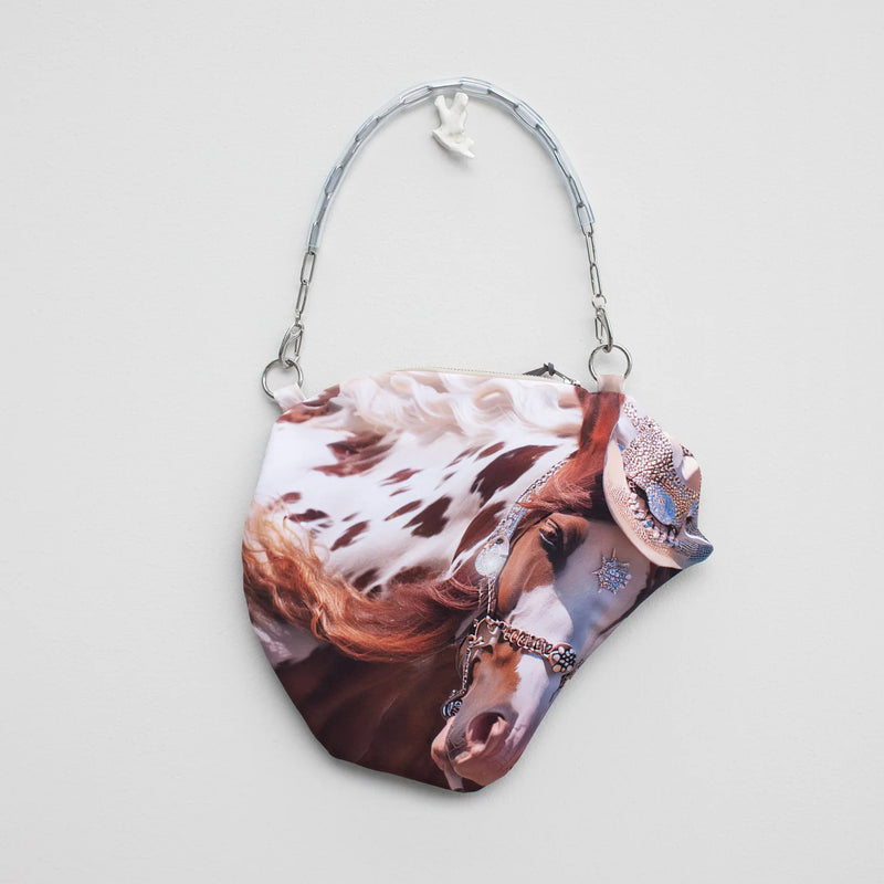 Handbag with a horse print on a light gray background