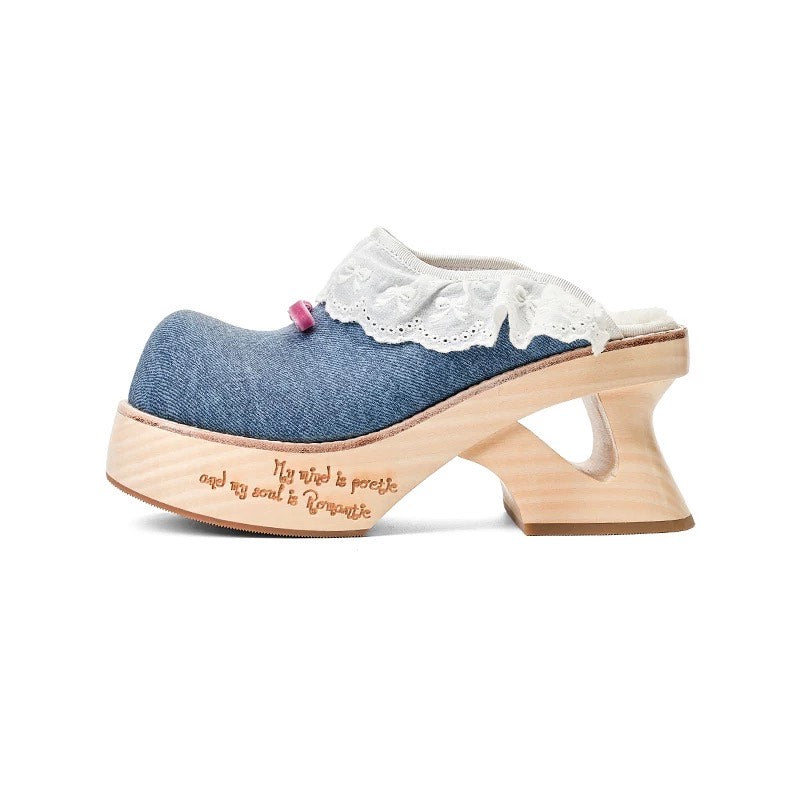 Blue denim clog shoe with wooden sole and white lace trim on a white background