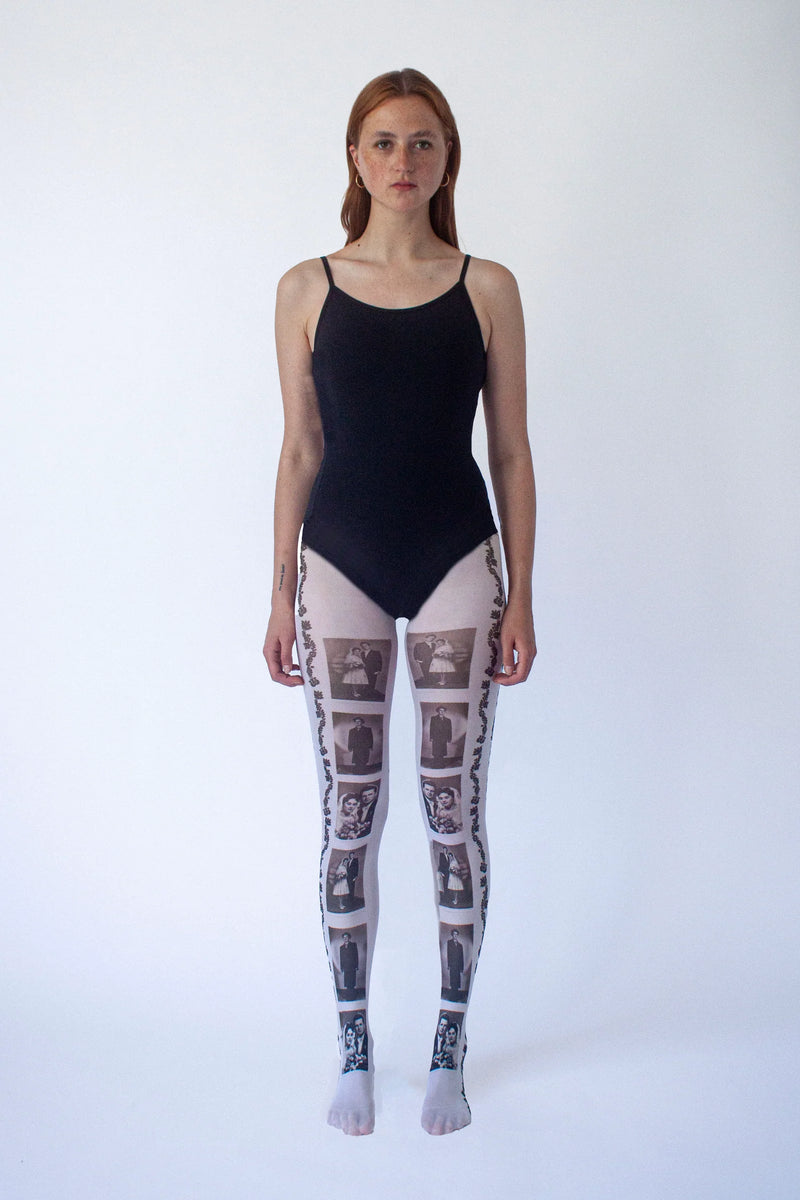 Person wearing a black swimsuit and patterned leggings on a white background
