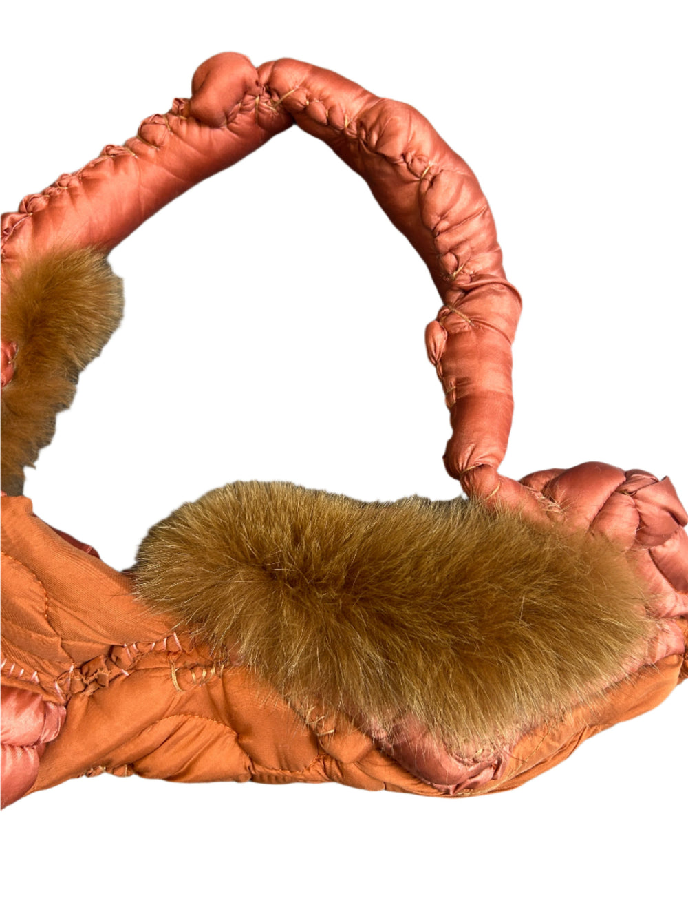  orange handbag with fur cuffs on a white background