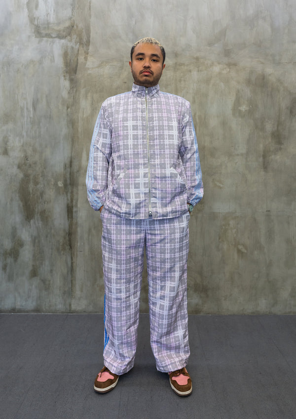 Front view of pastel tartan Tellavision jacket featuring zip-up closure, high neck collar, and relaxed fit with blue stripe sleeve detailing.