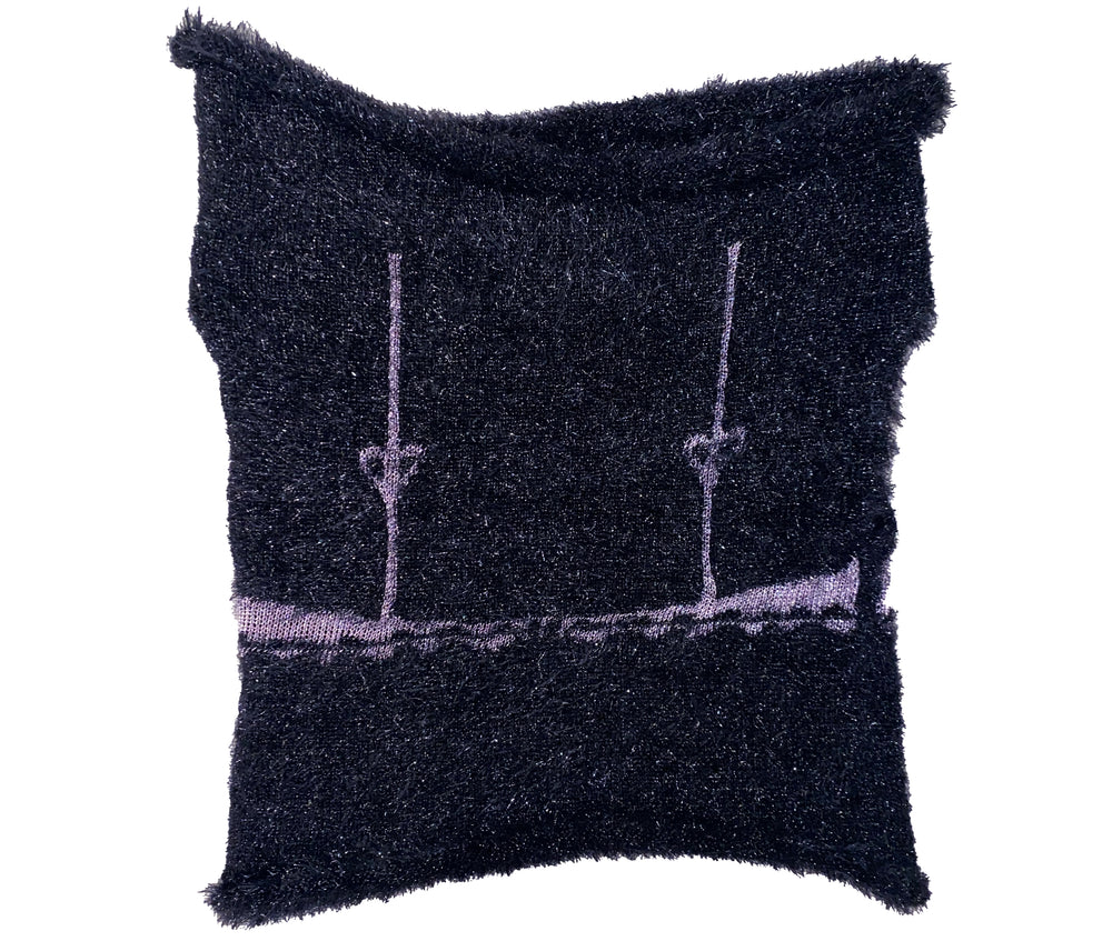 the back of a knitted black top with pink bra design 