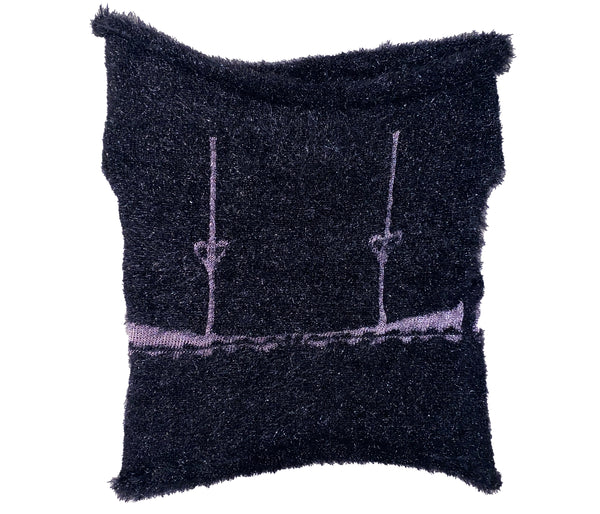 the back of a knitted black top with pink bra design 