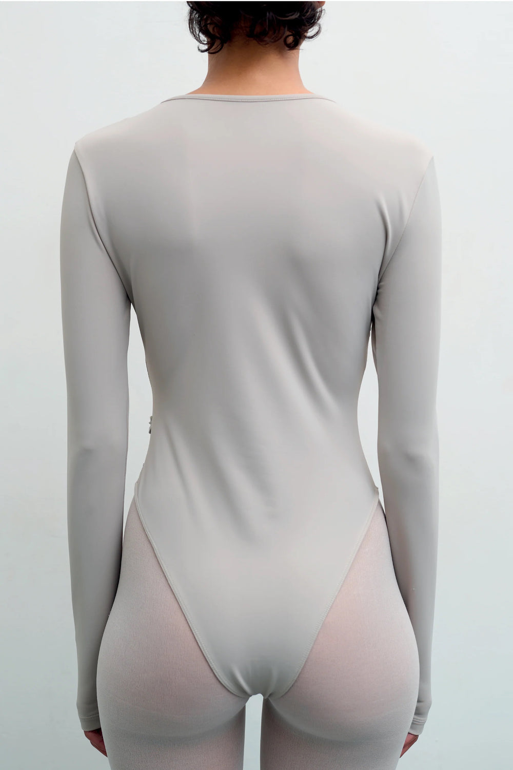 Back view of the GYGIL Chains Body bodysuit showing semi-sheer fabric and close fit.