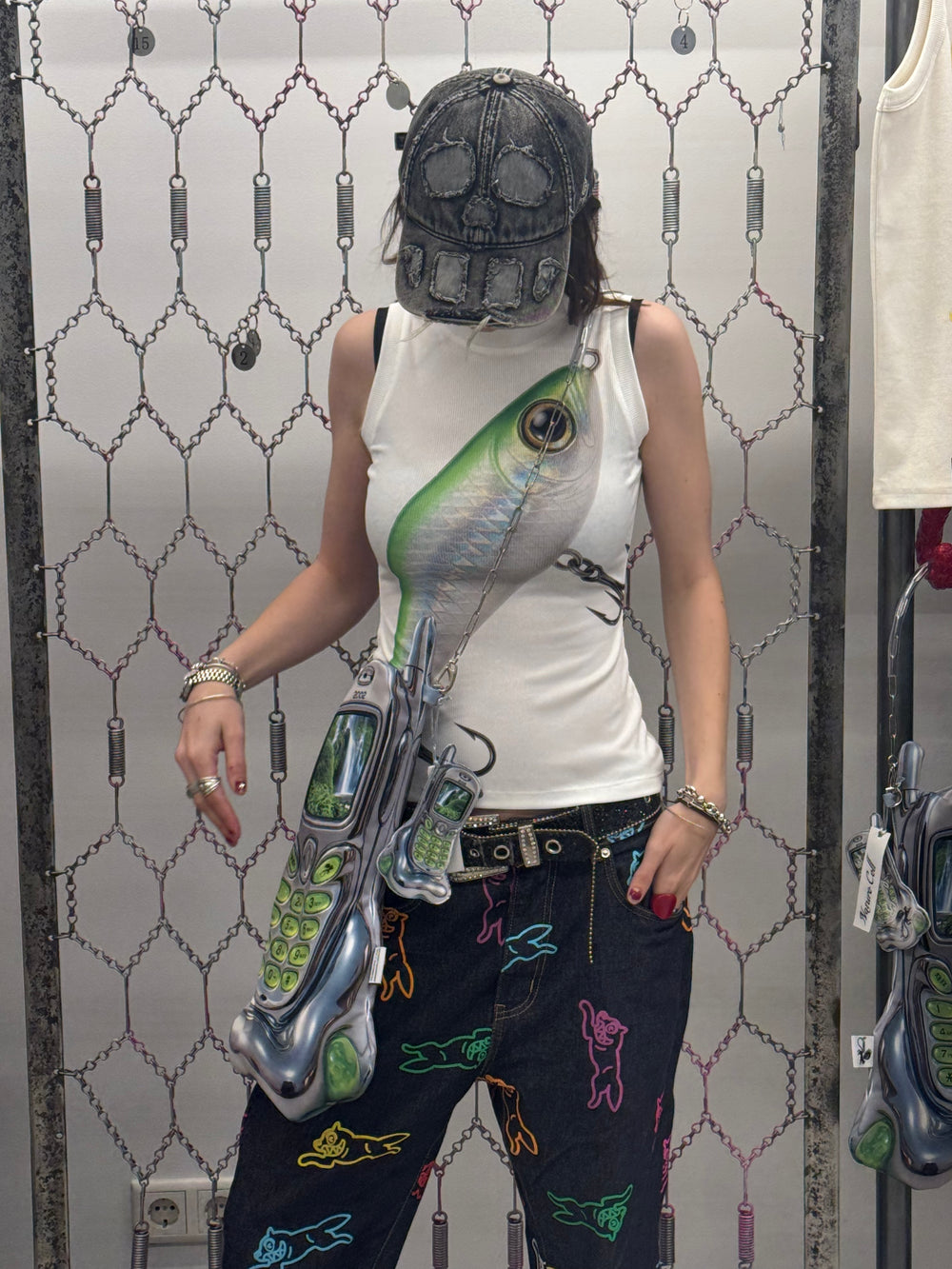 Person wearing a unique fish-themed tank top with a patterned background