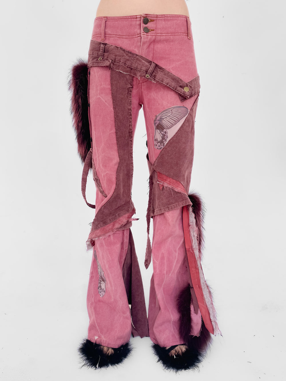 Pink jeans with decorative elements on a white background