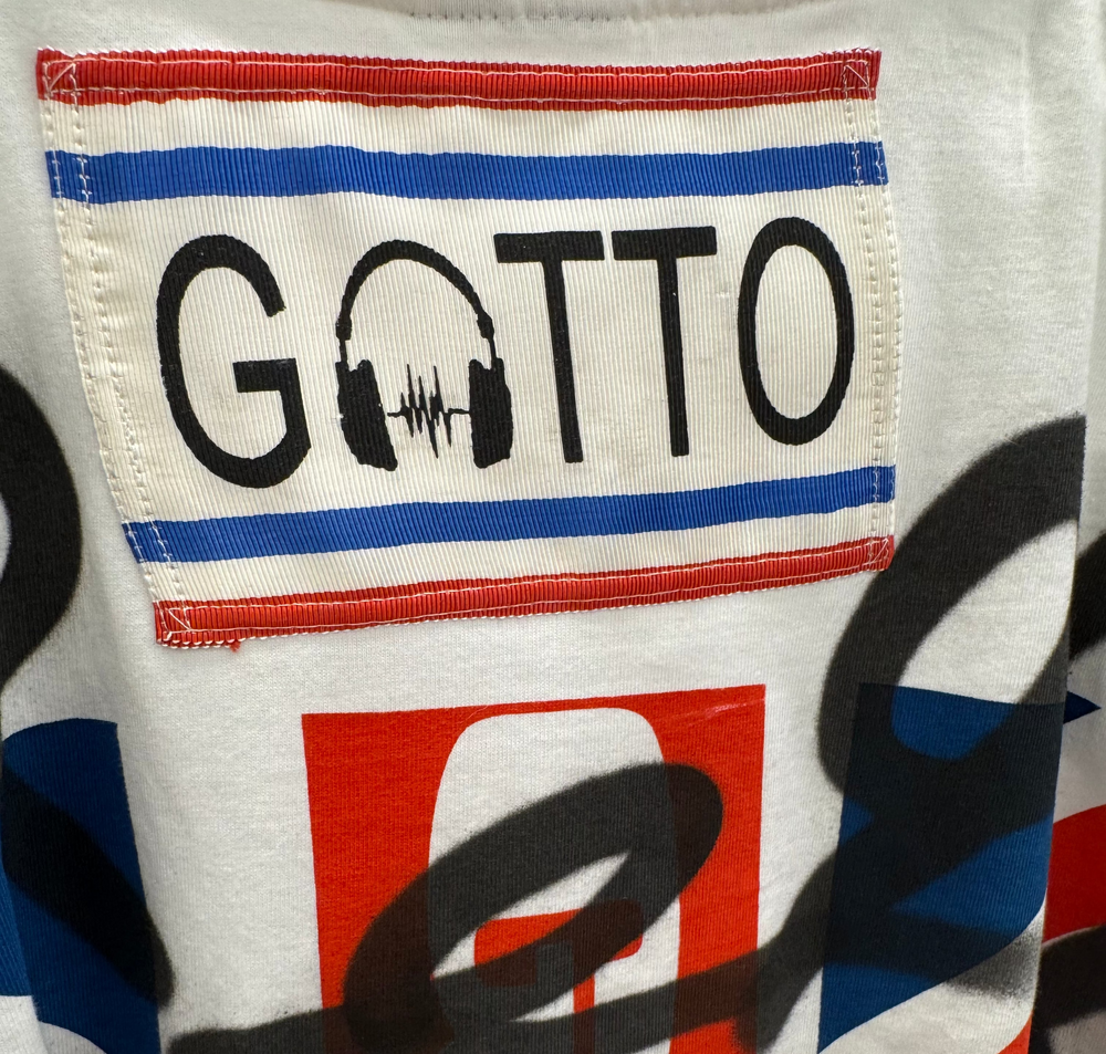 Close-up of a colorful fabric with 'Gatto' branding and design elements.