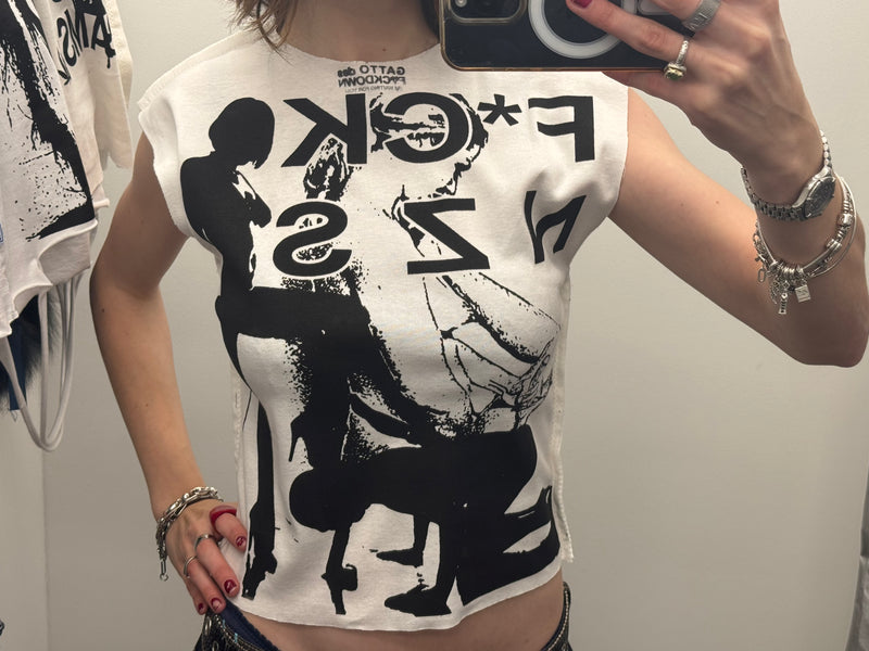 Person wearing a white t-shirt with black graphic design and text.