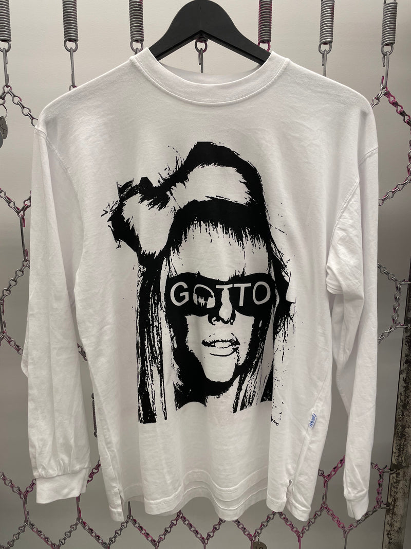 White sweatshirt with black graphic design of a face and 'GOTTO' text, hanging on a rack.