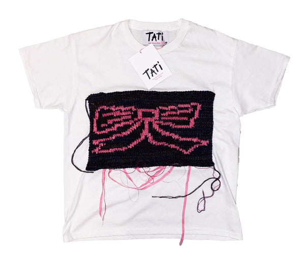 White t-shirt with black and pink design, featuring the brand 'Tati'.
