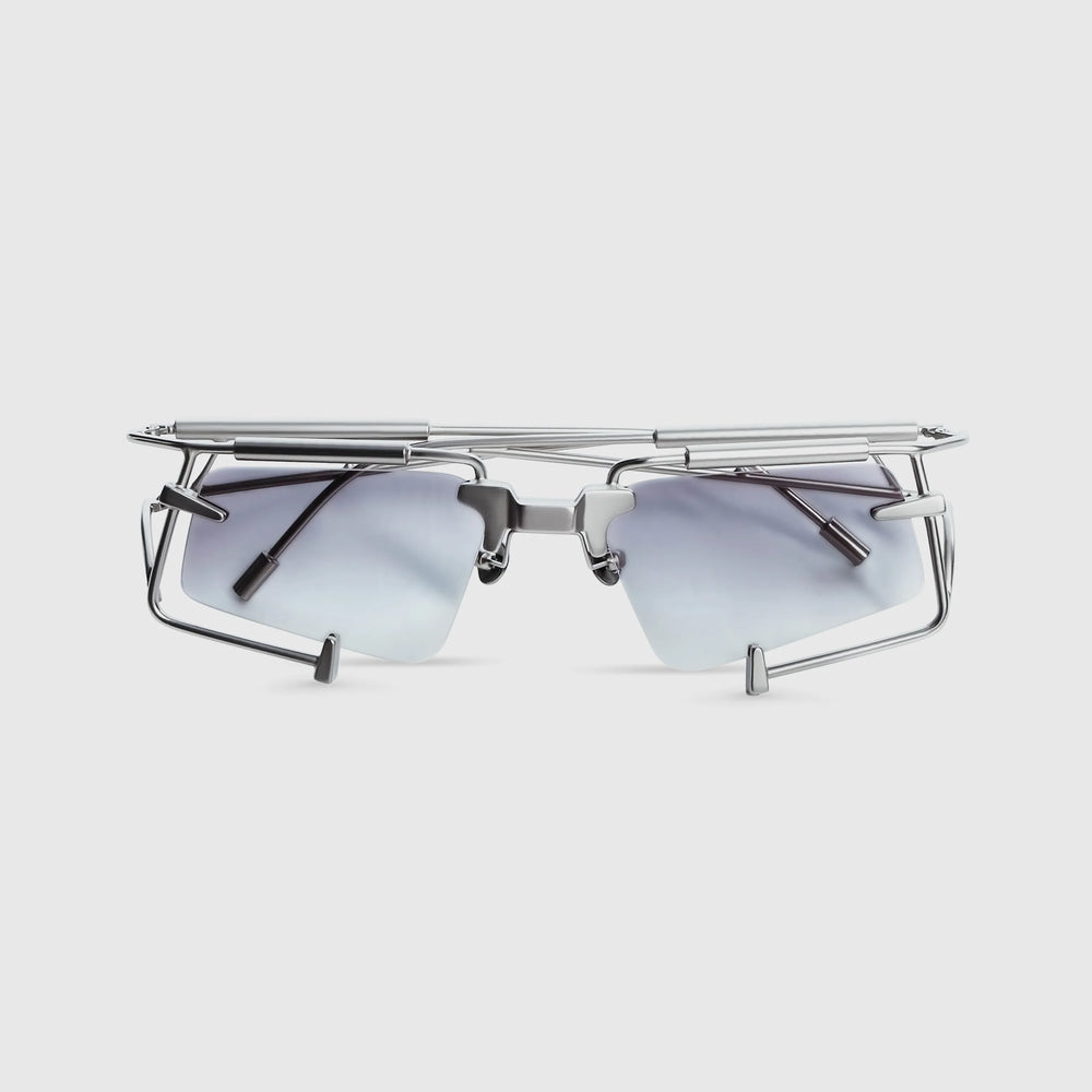 Sunglasses with metallic frame and blue-tinted lenses on a light gray background