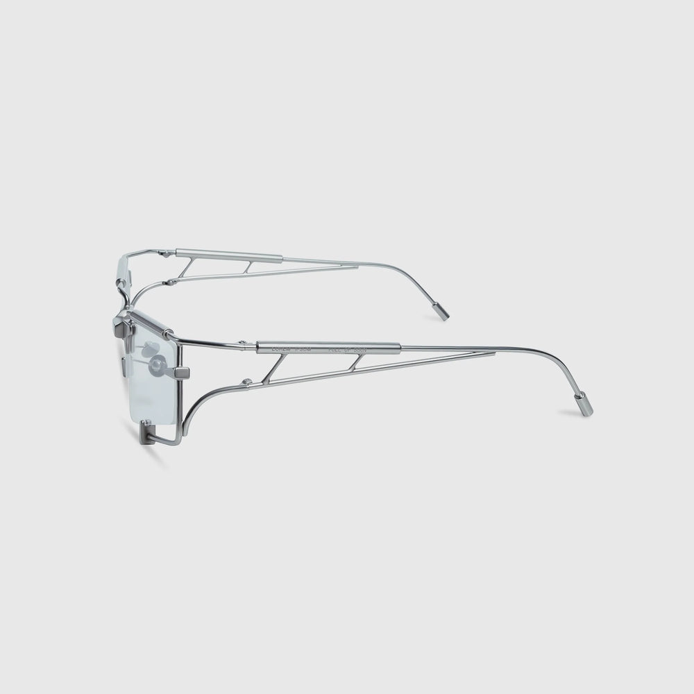 Silver eyeglasses on a light gray background