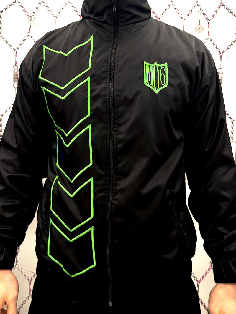 Black jacket with green geometric patterns and logo on a textured background dream unit


