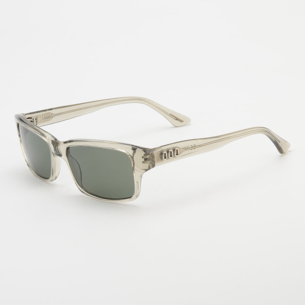 Sunglasses with a clear frame and dark lenses on a white background