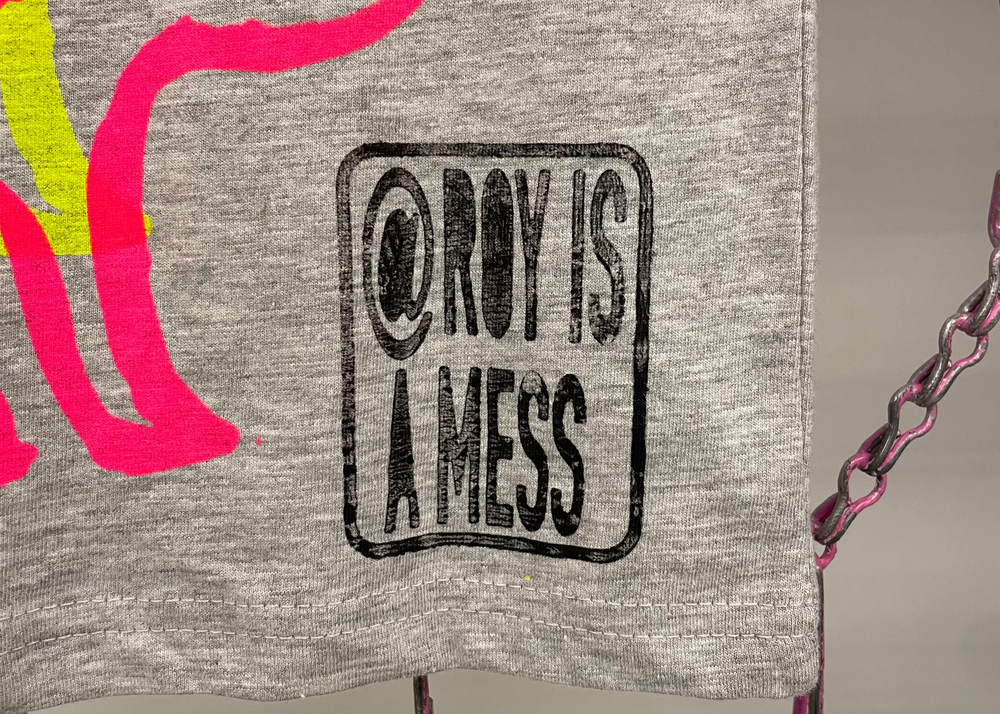 Gray sweatshirt with colorful graphics and text on a chain background