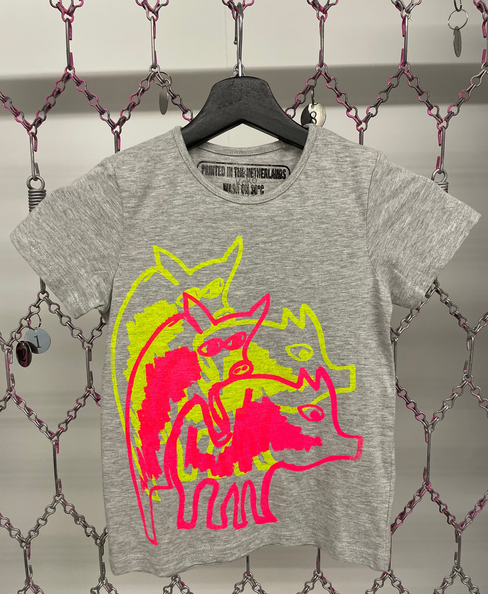 Gray t-shirt with a colorful graphic of a dog on a hanger against a chain-link fence background.
