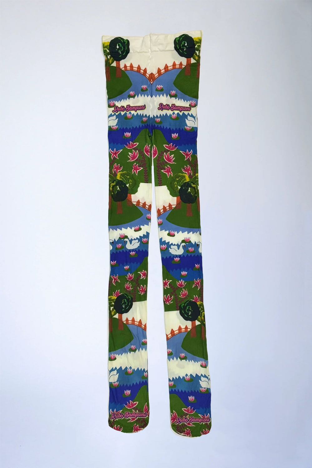 Flat lay front view of colorful scenic print leggings featuring swans, lily pads, trees, and arched bridges on a white background.