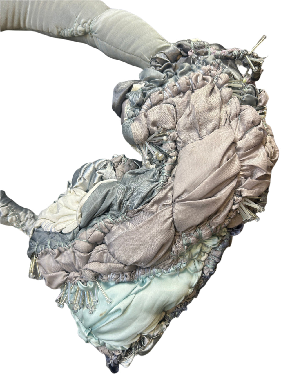 Decorative bag with ruffled details on a wooden surface