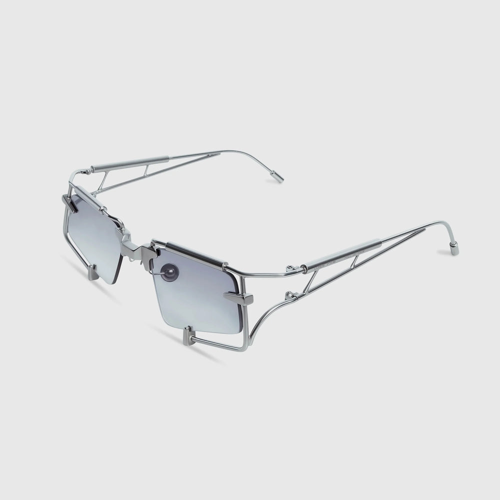 Sunglasses with thin metal frame and gradient lenses on a light gray background