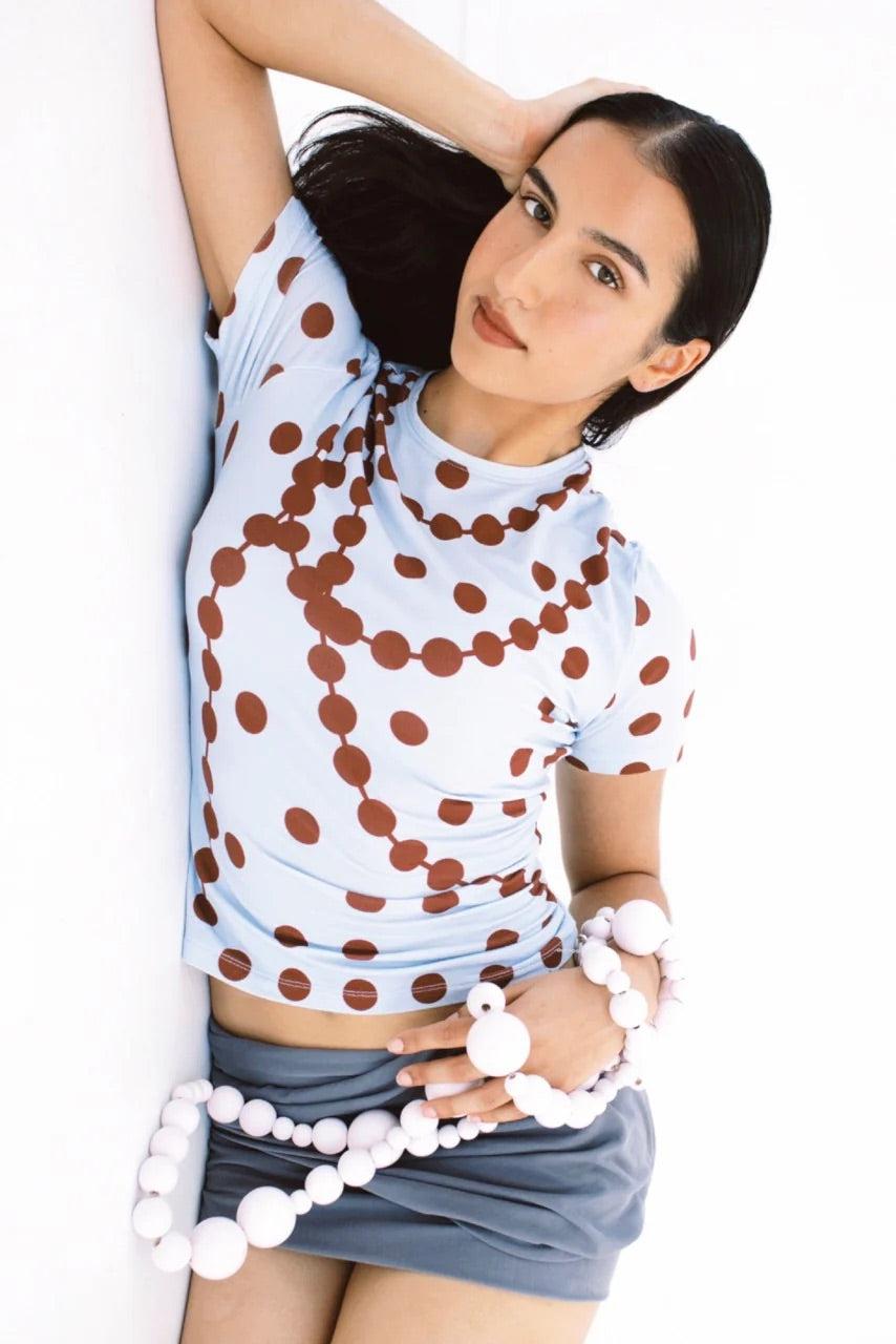 Model wearing the GYGIL polkadot short-sleeve t-shirt in blue and burgundy.
