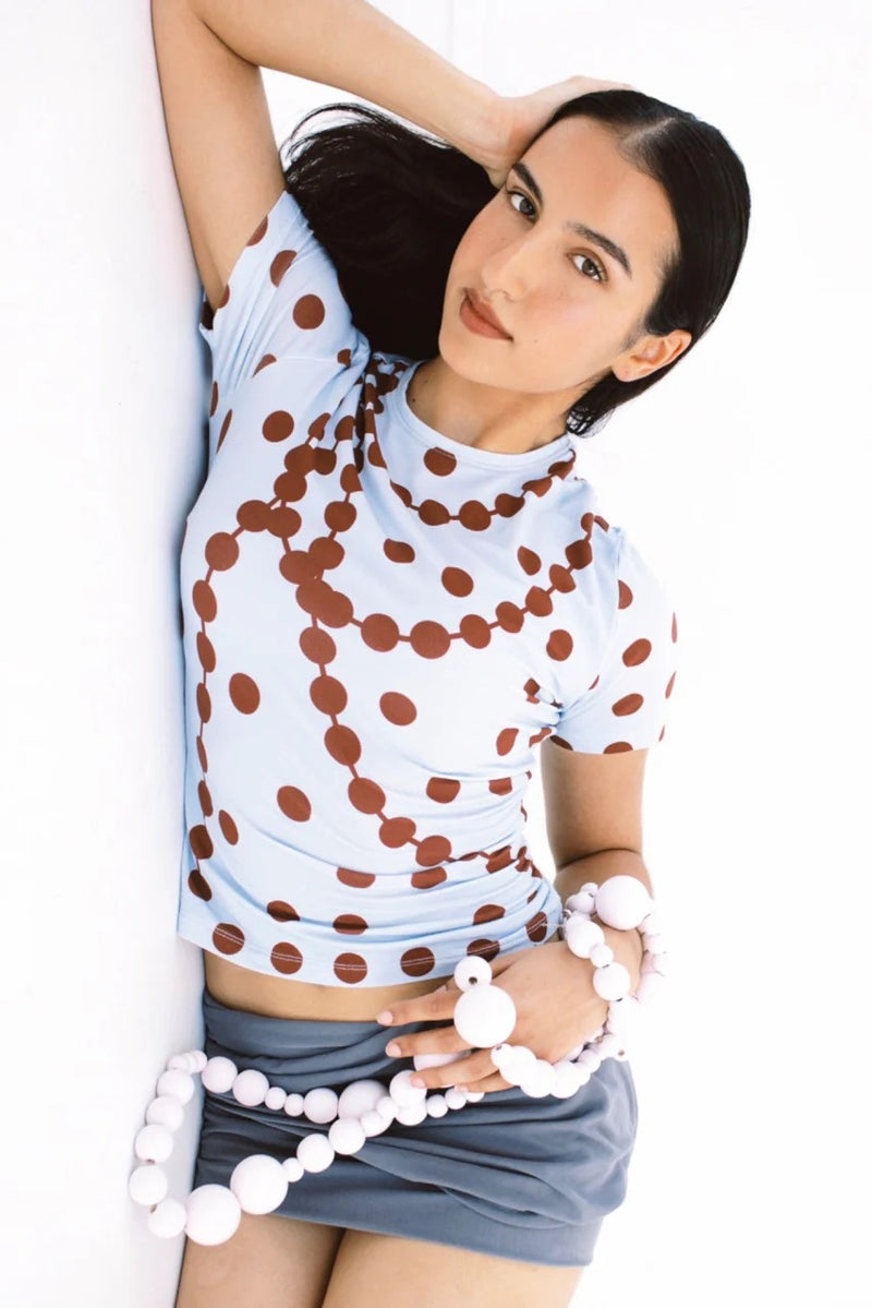 Model wearing the GYGIL polkadot short-sleeve t-shirt in blue and burgundy.