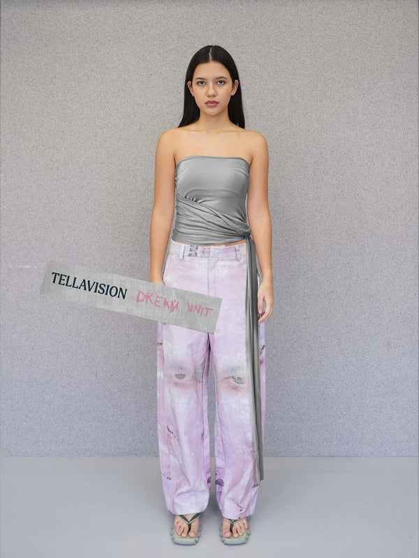 Model wearing grey Tellavision Drop Down Tube Top with draped wrap detail and pastel printed pants