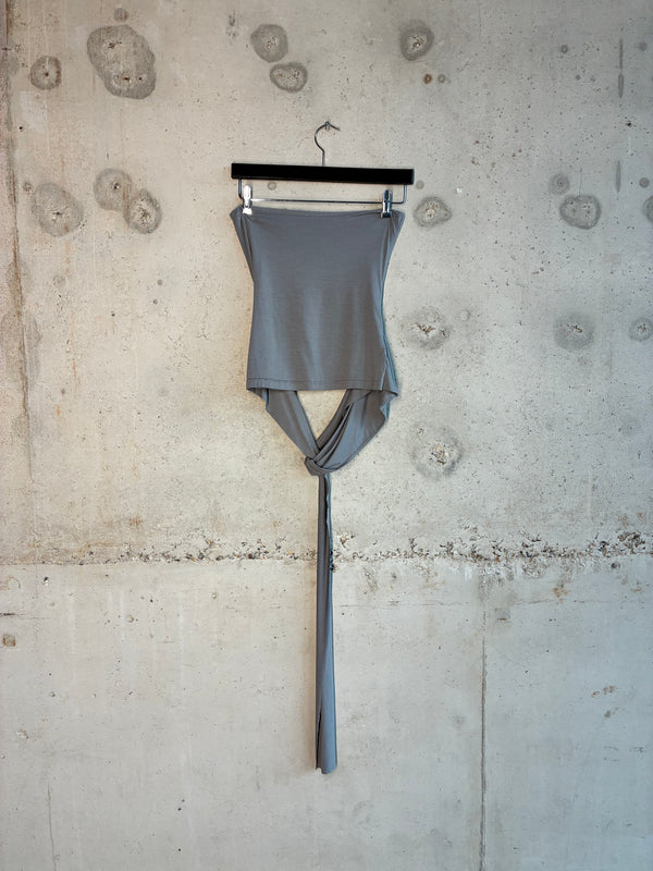 Drop down tube top is hanging on the wall with the product detail shot. 