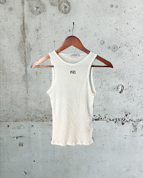 Cream ribbed Tellavision Wishes Tank with metal logo detail