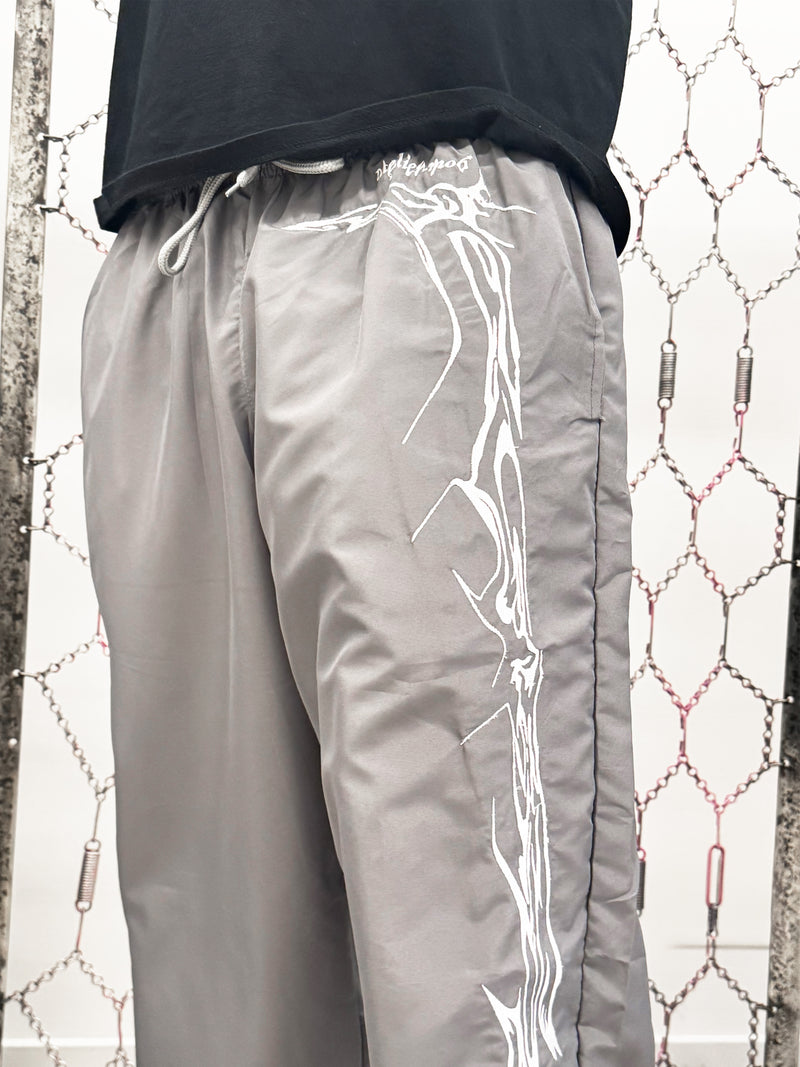 Gray pants with white tribal design on a textured background