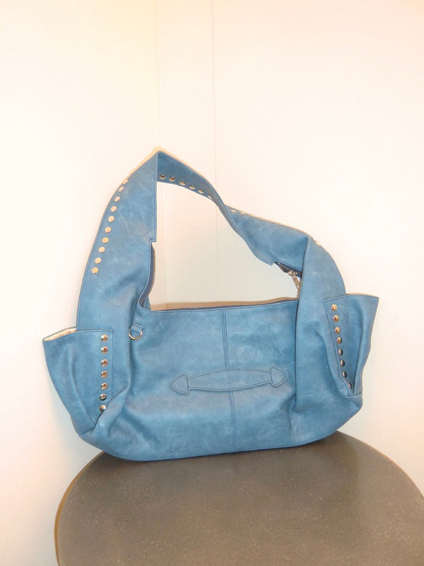 Blue handbag with studs on a white background
